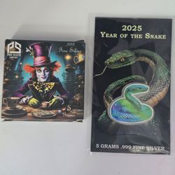 Two collectible 5 gram .999 fine silver pieces — 10 grams total pure silver.
• 2025 Year of the Snake – colorized snake design
• Mad Hatter – Pan Silv