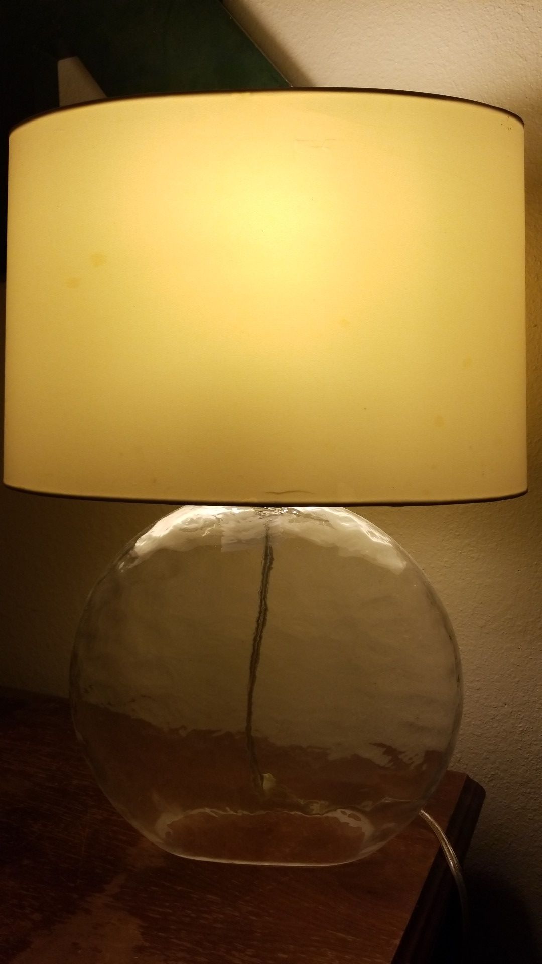 Hollow glass lamp with cream colored shade