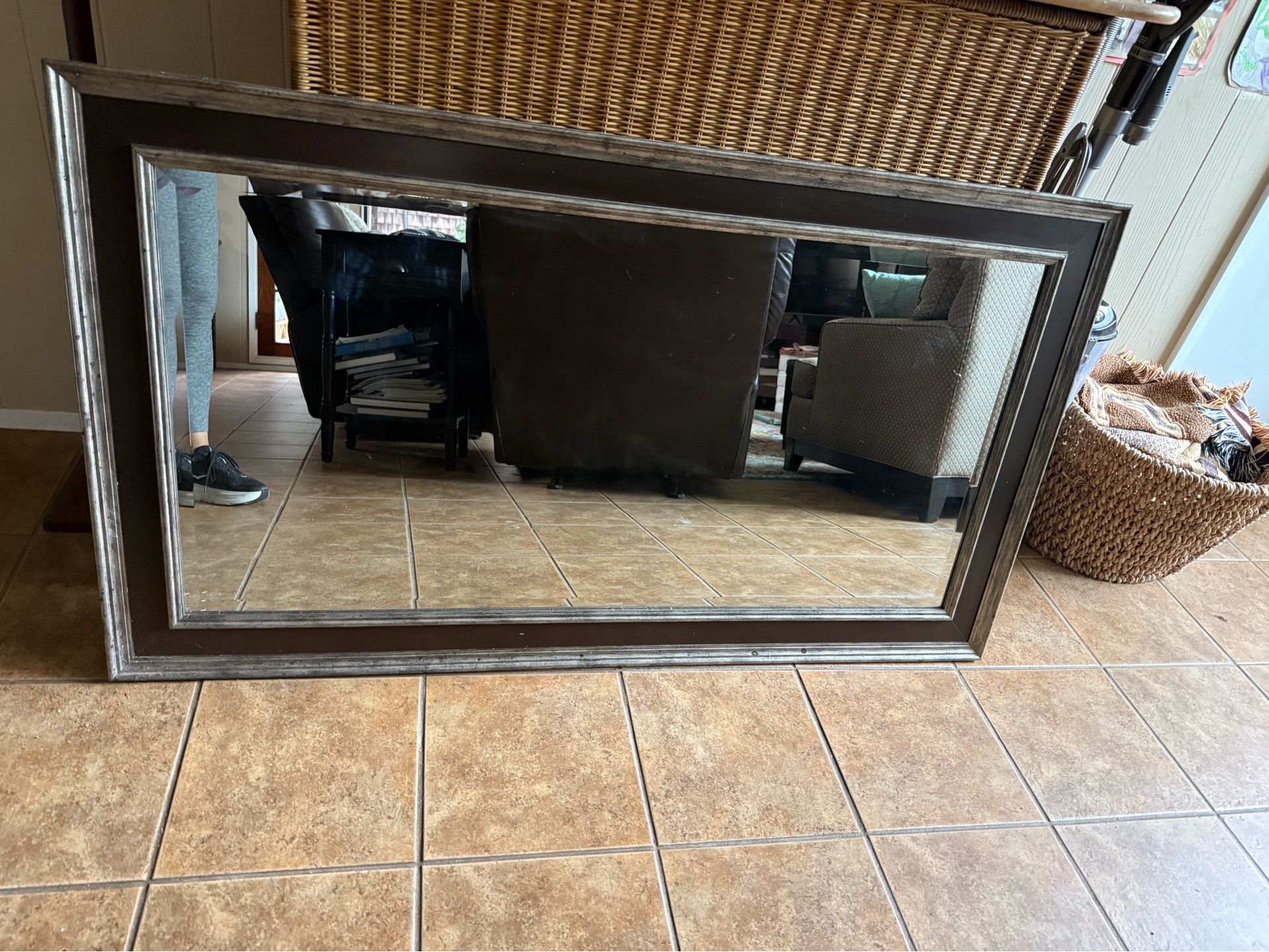 Wall mirror with silvery edge and brown trim