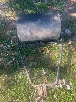 Black yard roller pull behind mower to roll down humps in the yard