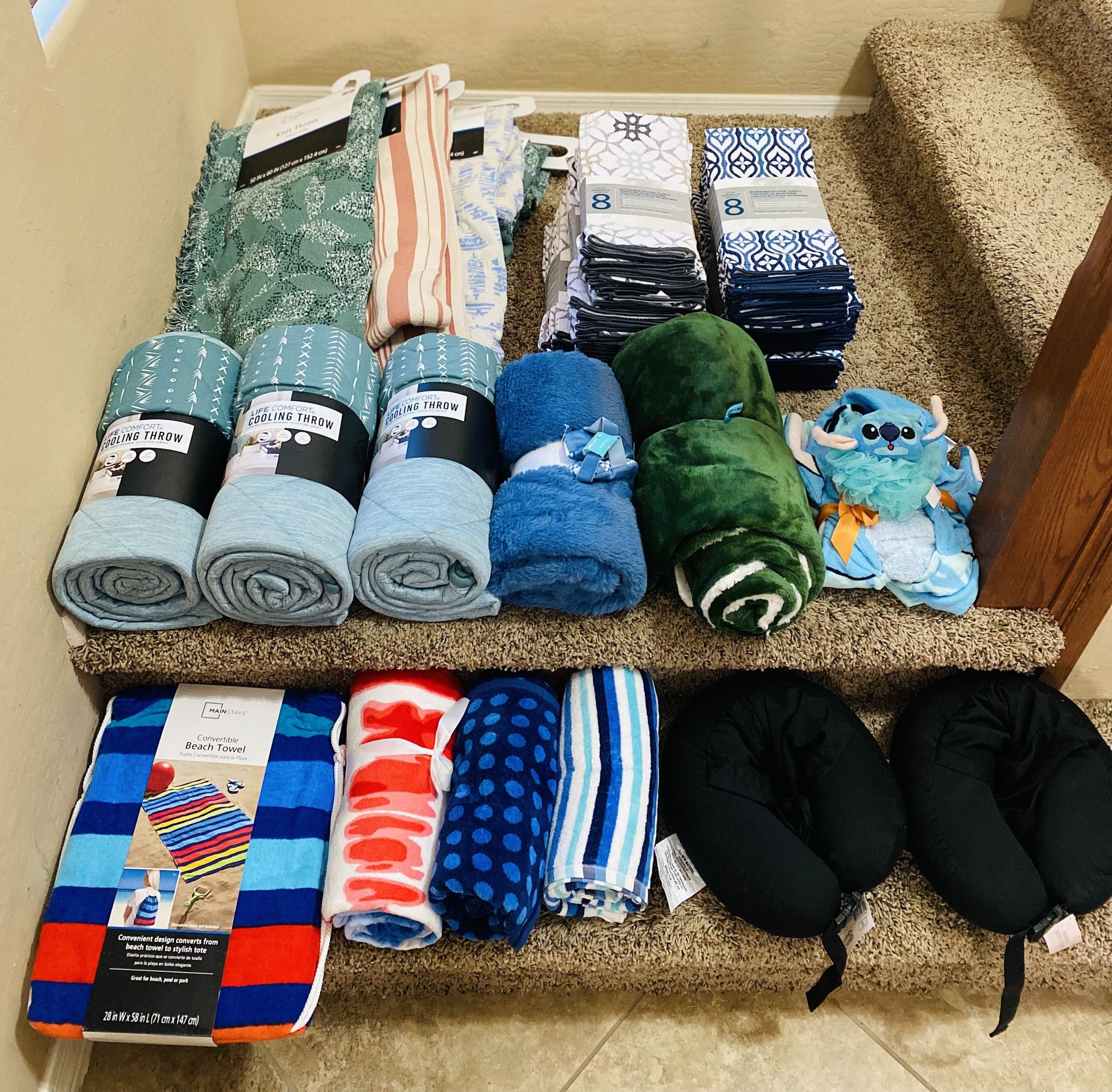 Brand new blankets, dish towel sets, and beach towels. Beach towels and travel pillows on the step are $5 each and everything else is $10 each. Or all