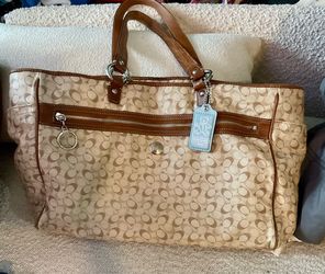 Coach baby diaper bag with blue tag.