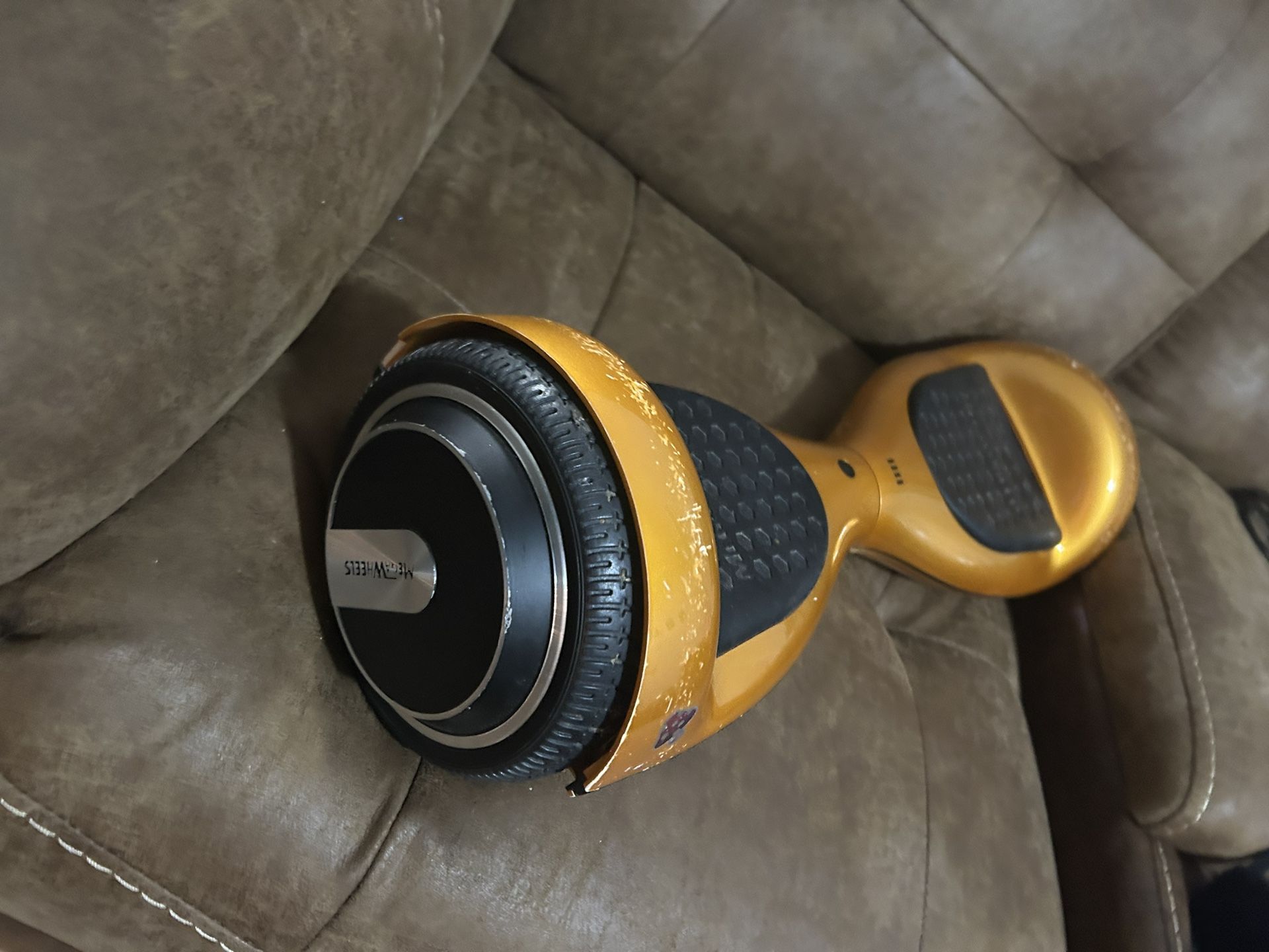 Sleek Gold Hoverboard. Black Foot Pads And Wheels .