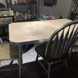 Table and three chairs