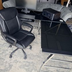 Black Glass desk with metal legs. Also included are new leather computer chair, Acer Monitor, Epson printer and Logitech keyboard.