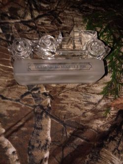 This is a paper waghit glass statue of an old car I am looking for at least 40