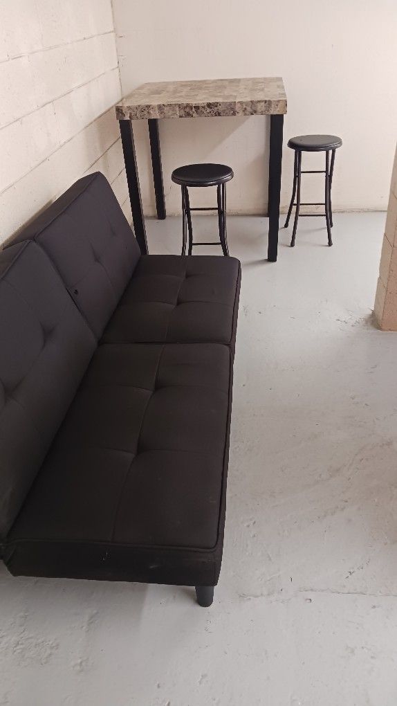 Futon And Table And Two Chairs