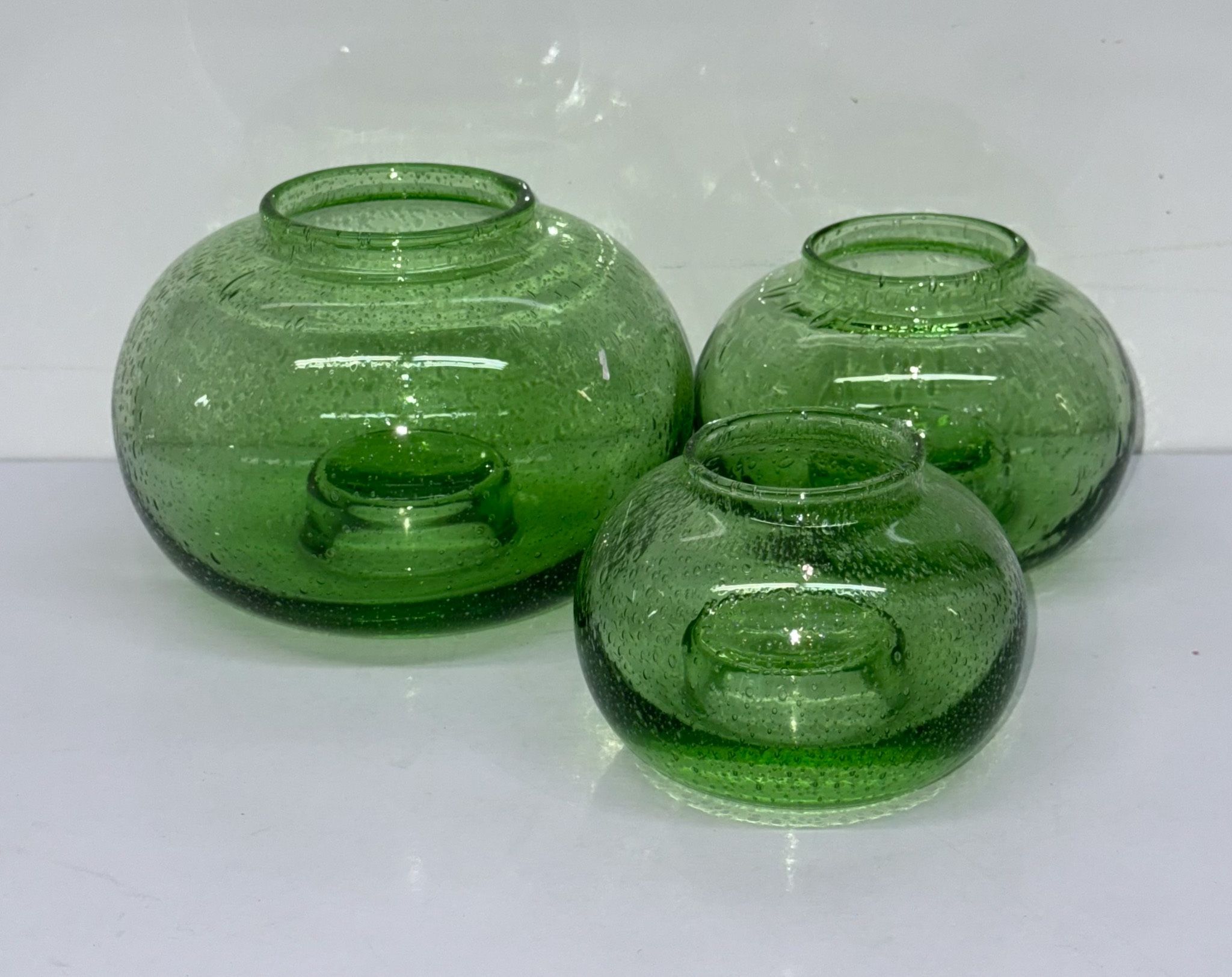 Trio of hand blown bubble, green glass globe candle holders