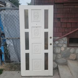 Wooden Entry Door With Four Vertically Embosed Floral Panels And Narrow Glass Sidelite Windows 36x77