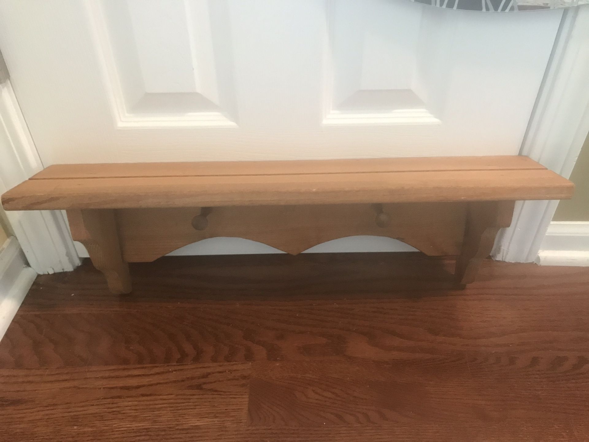 Small wood shelf with pegs