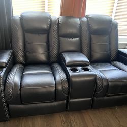 Black leather couch - reclining - LED lights - charging ports - cup holders -storage compartmentsp