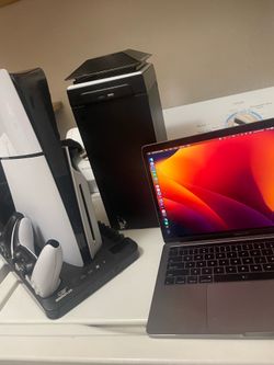 2 Xbox controllers 2 ps5 controllers, MacBook Pro with touch strip