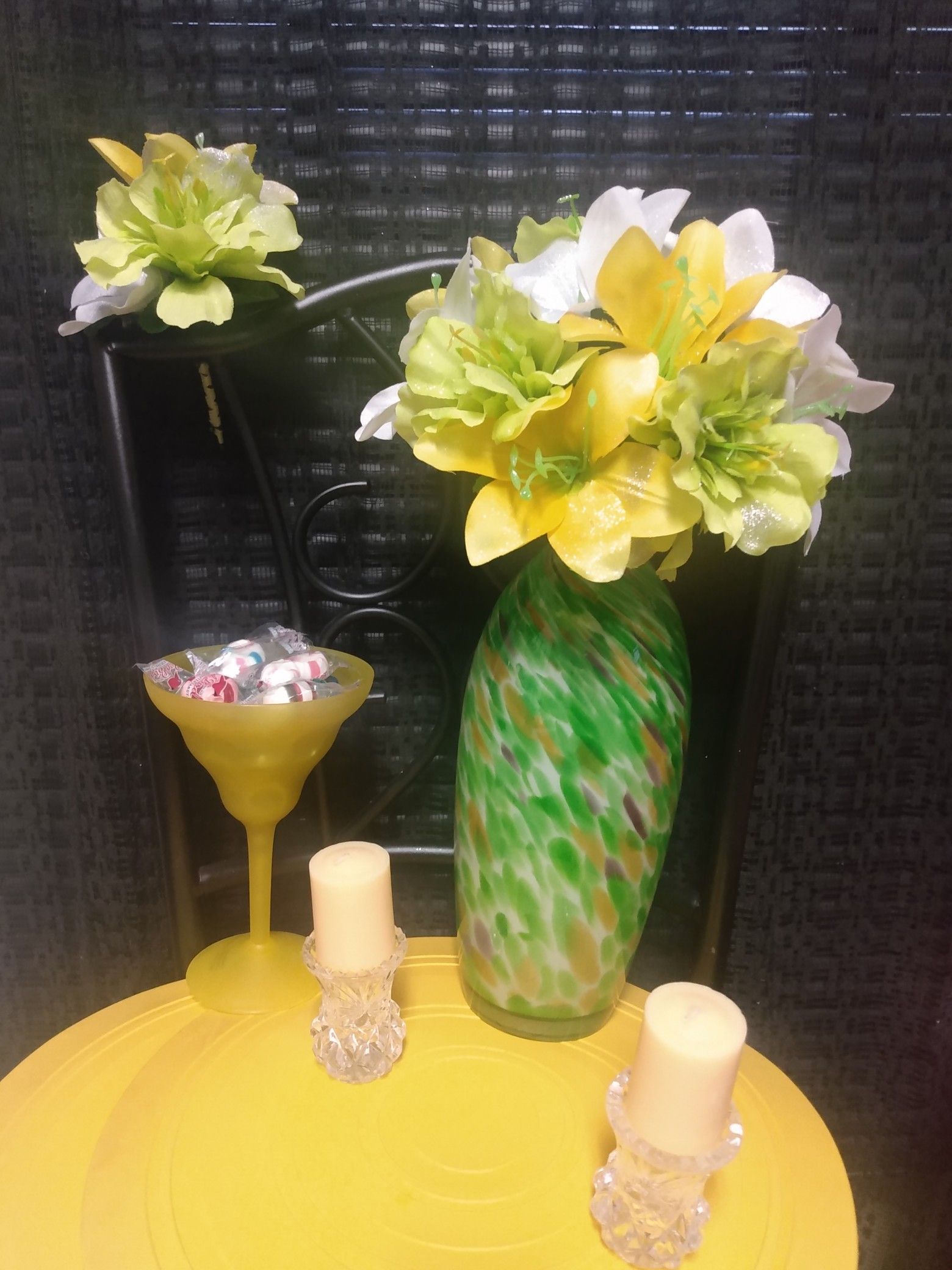 $45 Yellow/ lime green/ white flowers in a Multi colors on vase, boutonniere, lime candy cup, (2) vanilla candles, (2) candle glass holders.