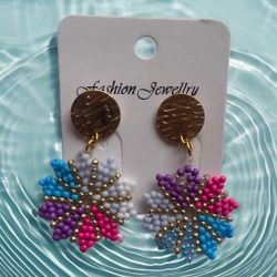 A pair of flower-shaped earrings made with colorful beads