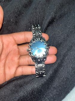 Silver watch with fire design and blue face