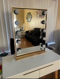 White vanity table with gold mirror