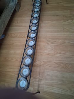 Metal stand holds twelve small candles