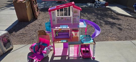 Barbie Dreamhouse Dollhouse with Pool, Slide and Elevator. Also comes with car and airplane.