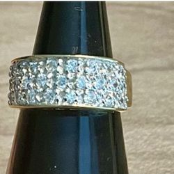Elegant gold-tone band ring with multiple clear pavé stones. Sparkling clear stones add refined shine for everyday or special occasions. Comfortable w
