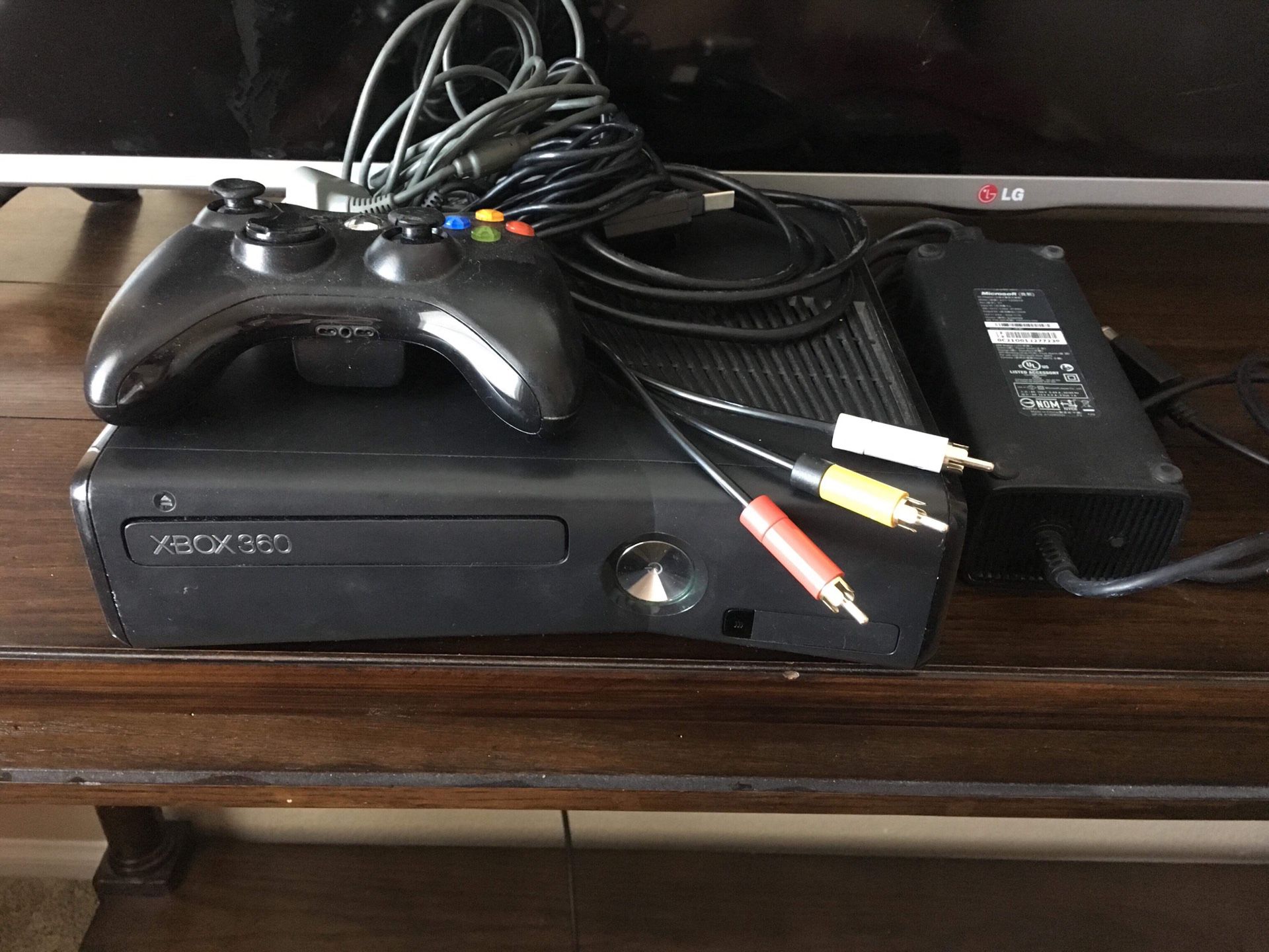 Black Xbox 360 slim with a 250 GB hardrive and new controller and controller chargers