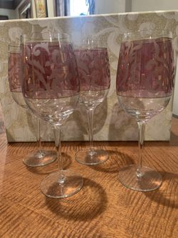 Beautiful Set of 4 glasses/ stemwear. Wine, water, icetea, lemonade..many uses. Cranberry glass with gold band and frosted embellishments