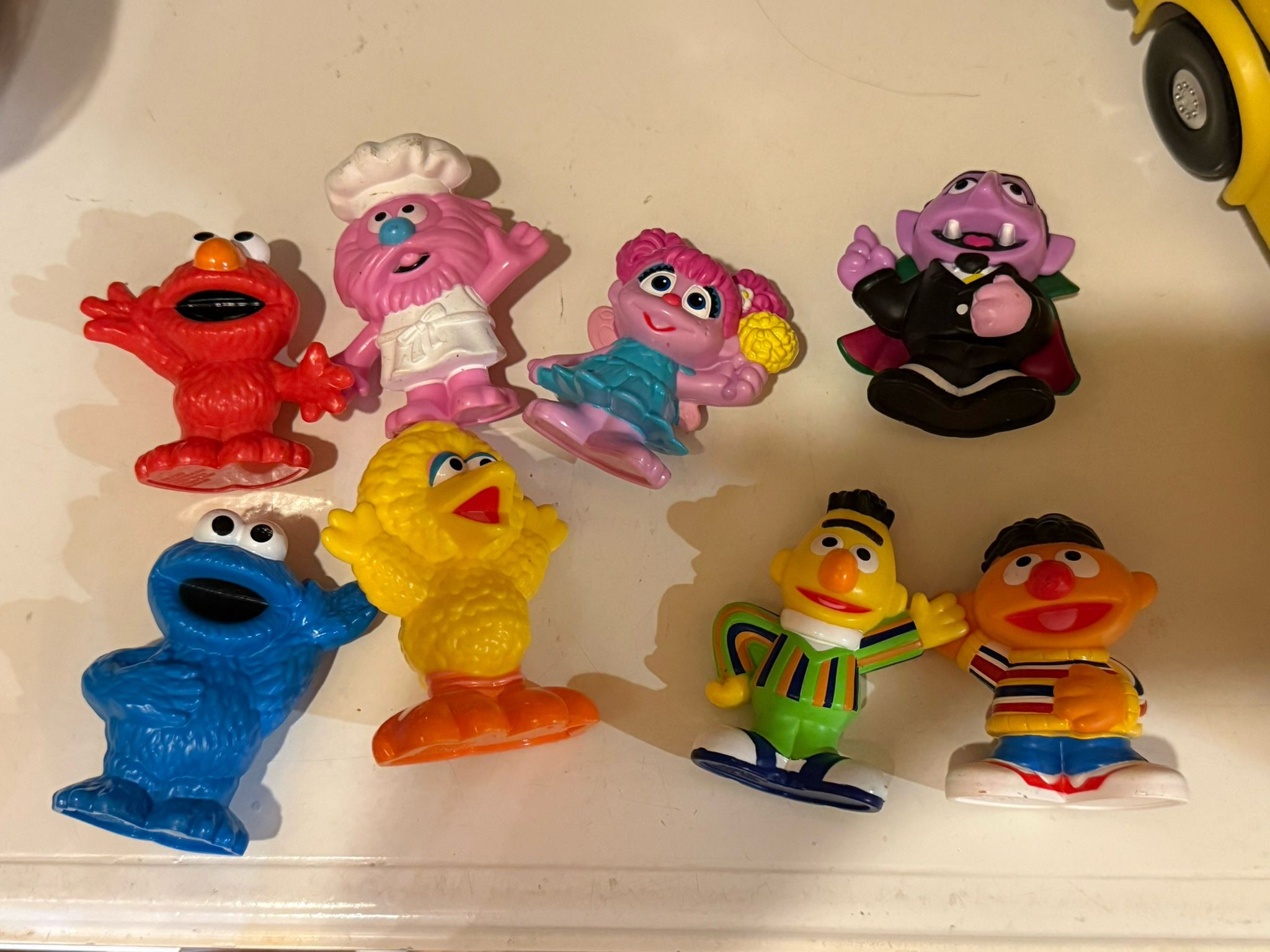 Sesame Street figures and Cocomelon Musical Bus And Figurine