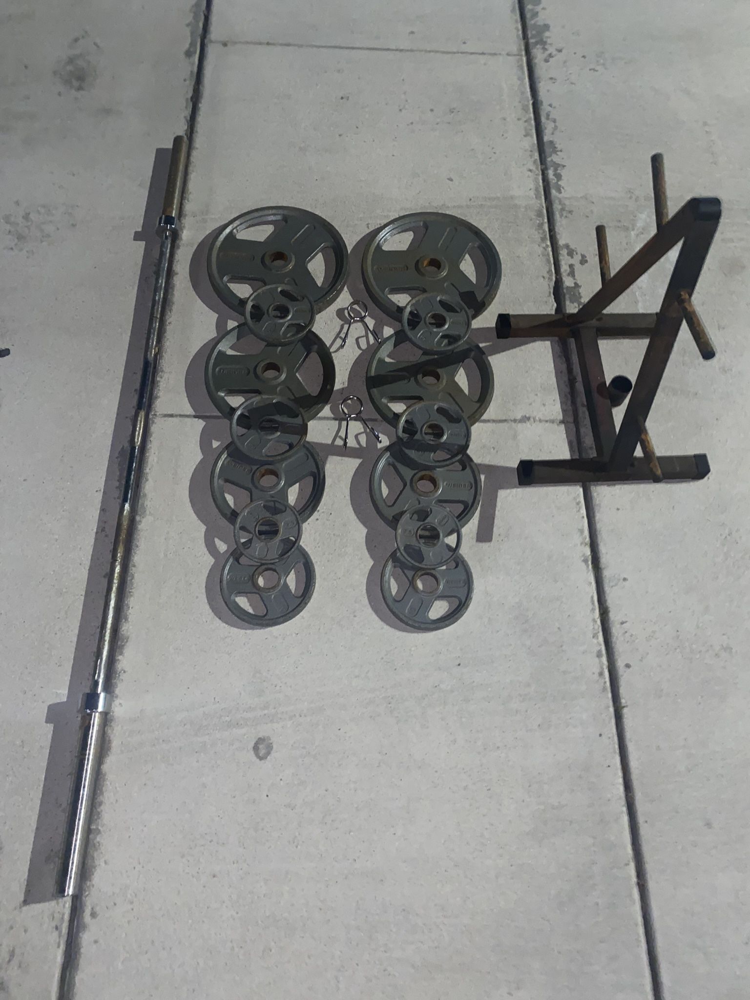 Weight plate set with rack and Olympic barbell 300lbs total 