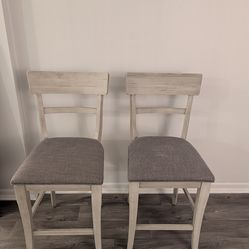 Two barstool height dining chairs