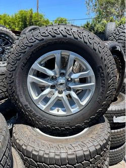 18”. STOCK CHEVY WHEELS AND ALL TERRAIN TIRES