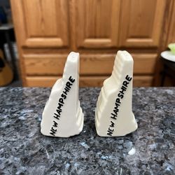 Vintage Ceramic New Hampshire Shaped Pair of Salt and Pepper Shakers.  Preowned no stoppers.  Size approximately 3 inches tall.  Preowned. 
