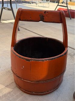 antique red-lacquered wooden Chinese water bucket with an arched overhead handle