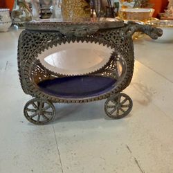 An antique ormolu and glass carriage-shaped jewelry box.  Ormolu, a French term meaning "gilded with gold," refers to the technique of applying a thin