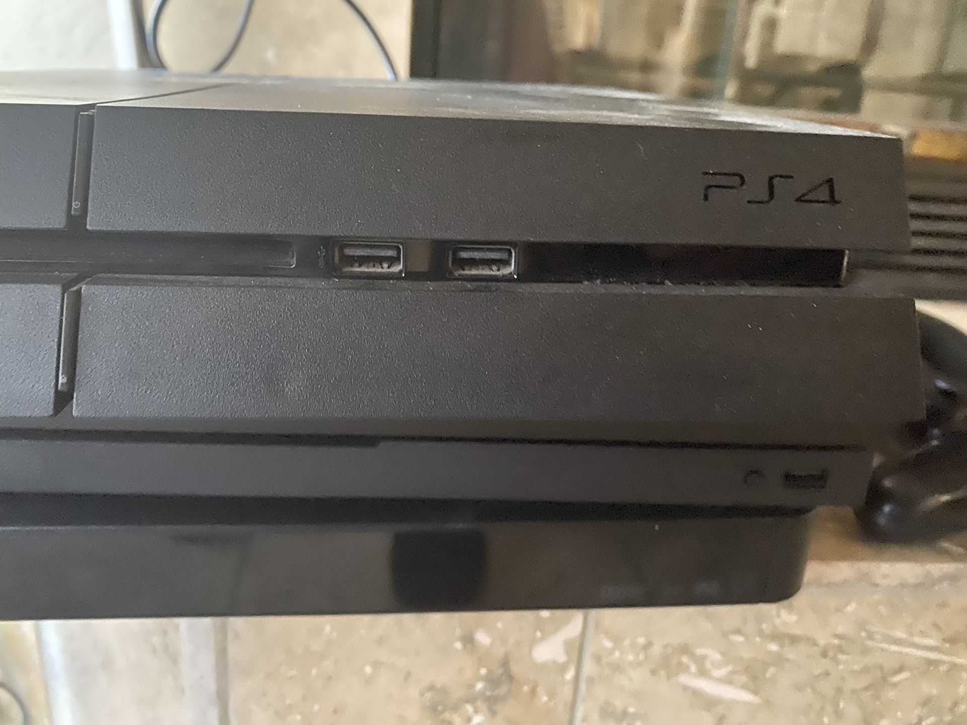 PS4 with numerous games and controller