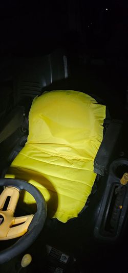 Riding mower seat with arm rest