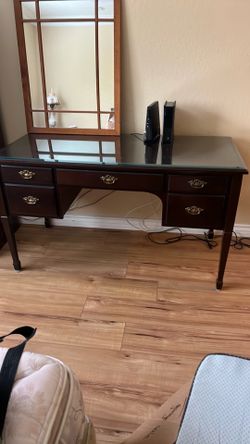 Dark wood desk with bevel glass top