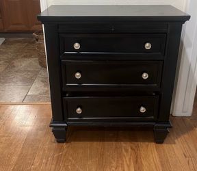 Black dresser with nightstand
