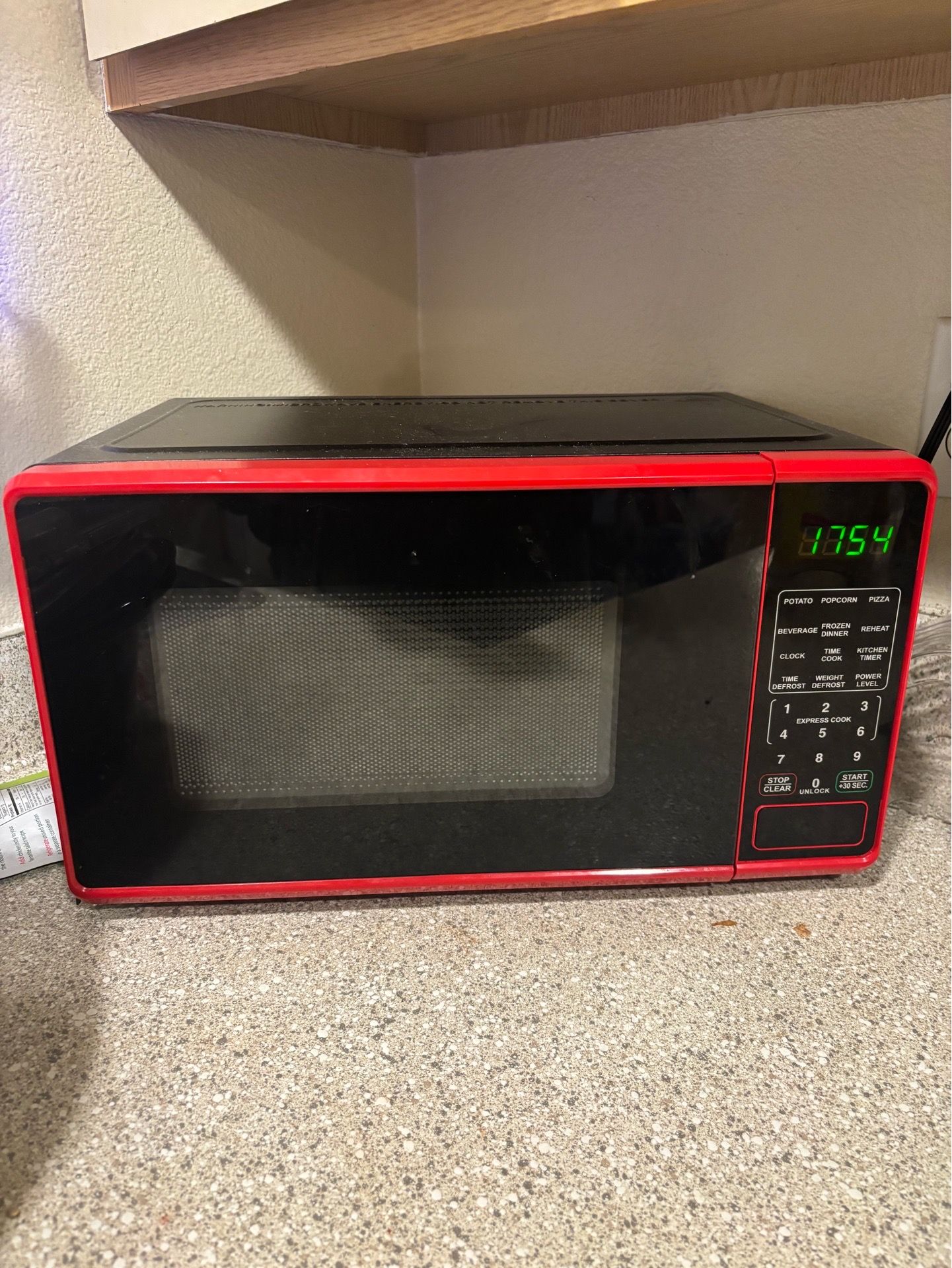 700 watt microwave. Red less than 1 year old.