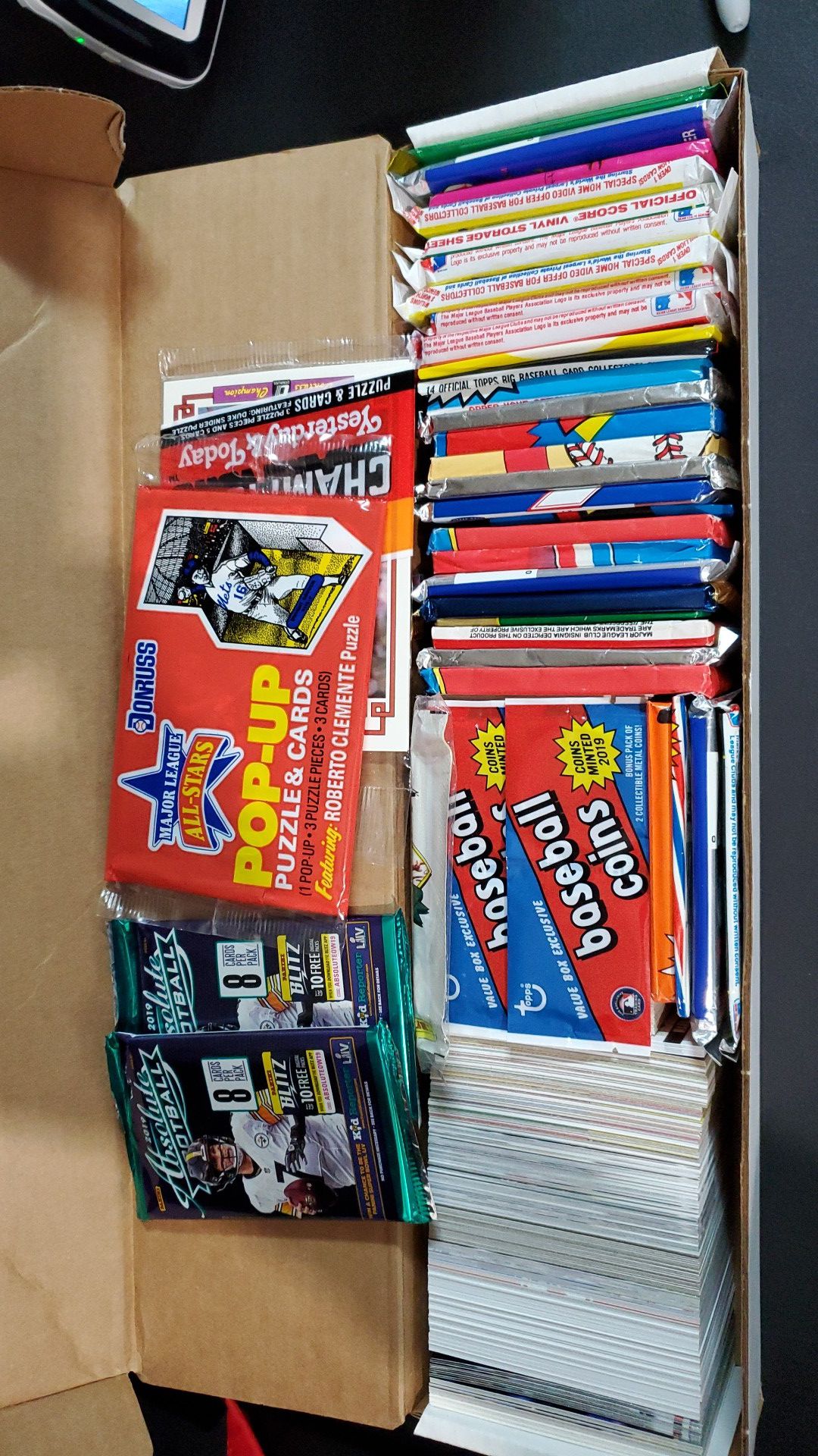 Box of baseball baseball football cards with unopened packs
