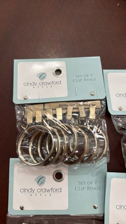 7 packs of Cindy Crawford home curtain clip rings in warm gold color