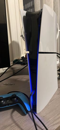 Playstation 5 slim 1tb with blue controller and headphones