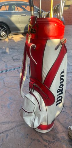 Vintage Wilson Red / White Golf Bag With Strap and several assorted golf clubs