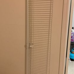White metal shelf with brackets