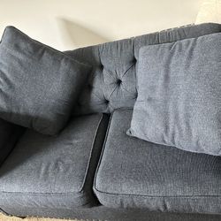 Blue couch with pillows 