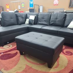 Contemporary Black Faux Leather Sectional With A Matching Ottoman