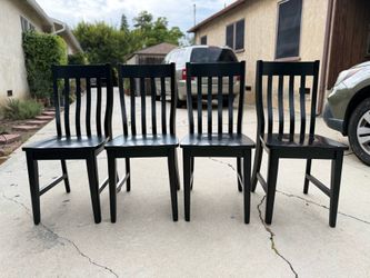 Four all wood dining room chairs