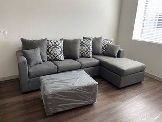 Brand new grey sectional with free ottoman
