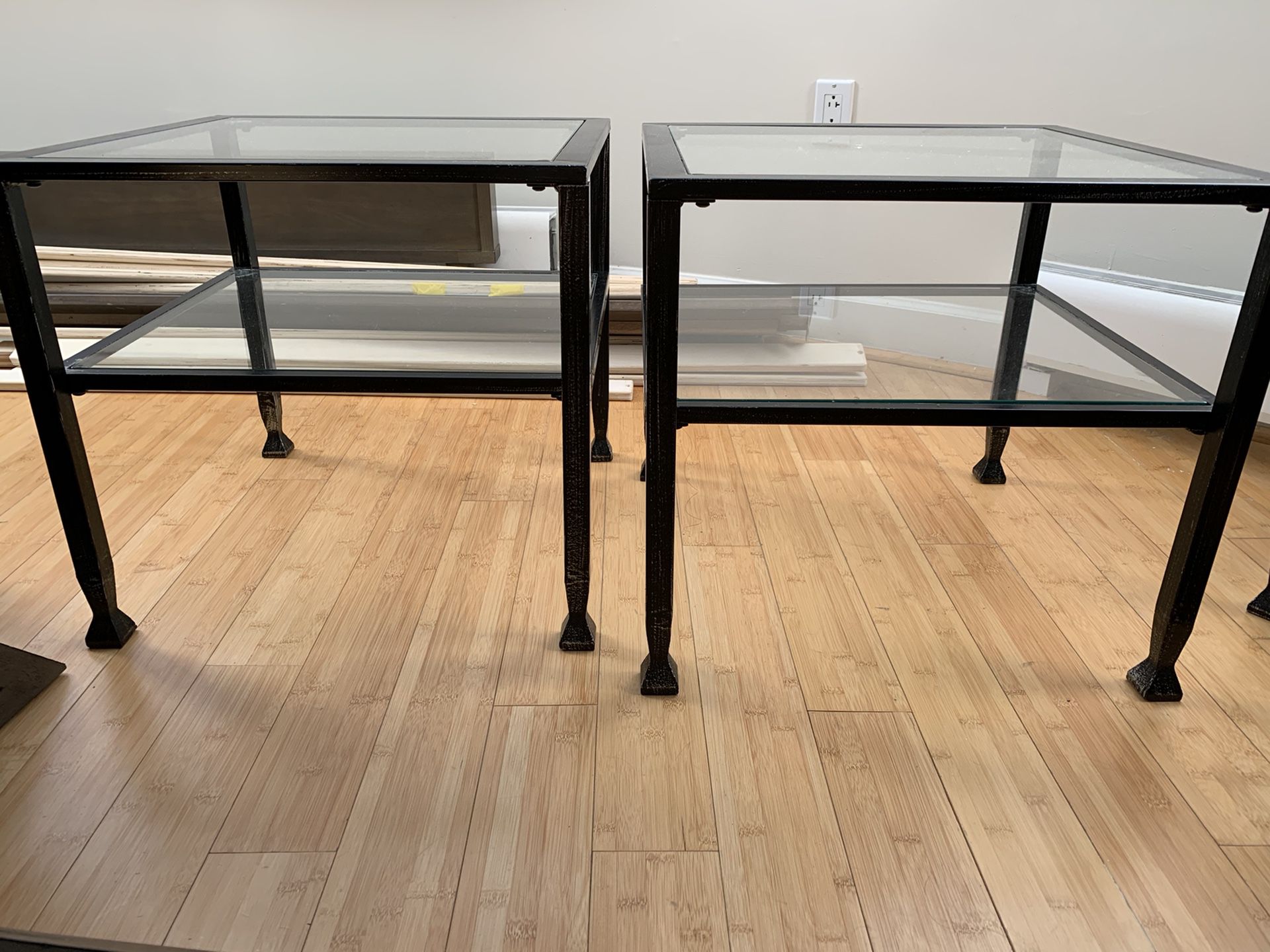 2 heavy metal (wrought iron?) and glass square end / side table tables black with extra shelves under top glass. Very nice. Dimensions 20 x 20 x 18H