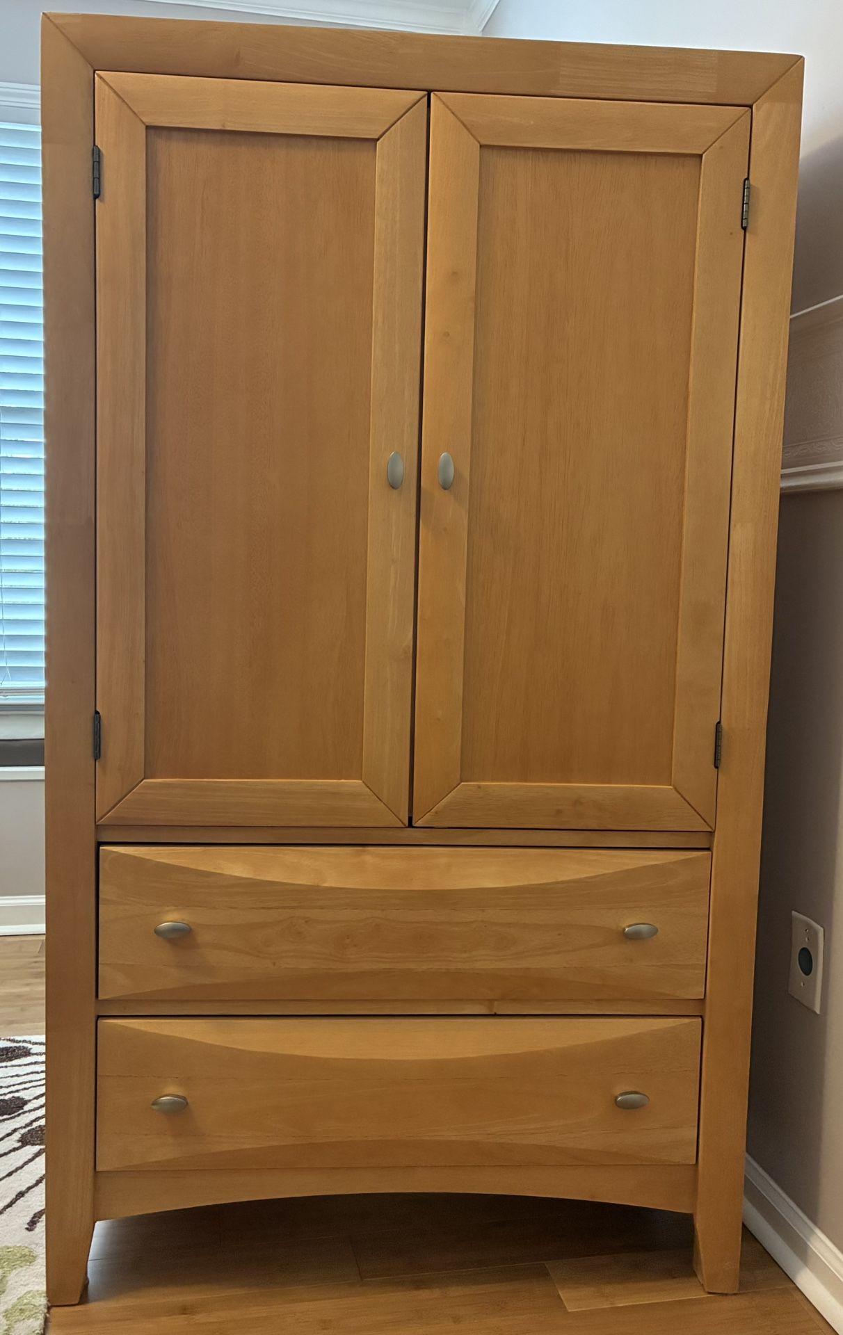 Solid Maple Wood Armoire with 2 bottom drawers and 2 upper doors with an interior closet rod and one shelf.
