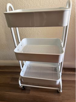 white metal trolley with three shelves