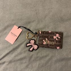 NWT Juicy Couture Pink Card Holder with Heart Keychain Fob  NWT Juicy Couture Pink Card Holder with Heart Keychain Fob. Features a bow pattern and a h